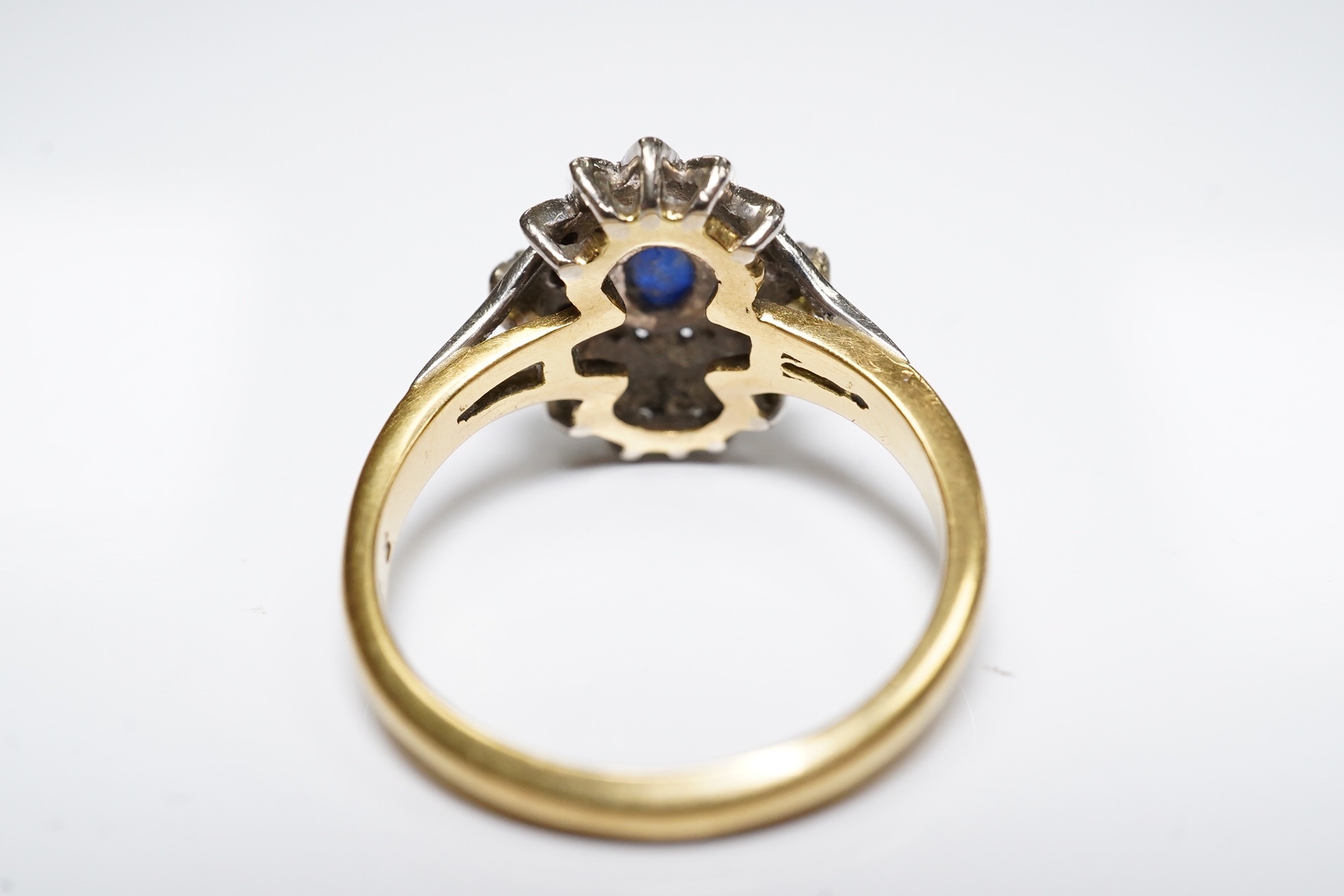 A modern 18ct gold, sapphire and diamond cluster set ring, size M/N, gross weight 4.6 grams. Condition - poor to fair